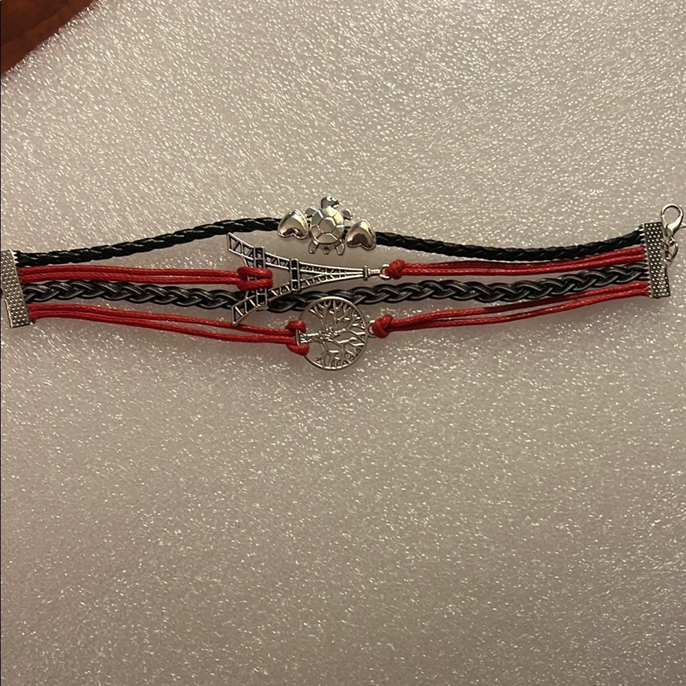 Red and Black Multi-Strand Bracelet with Charms, turtle, Eiffel Tower, tree.